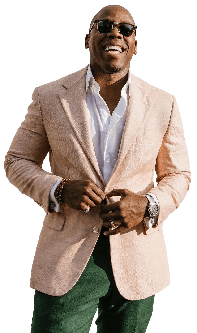 Brian Burnett, founder & master tailor, in a pale pink windowpane jacket and green trousers